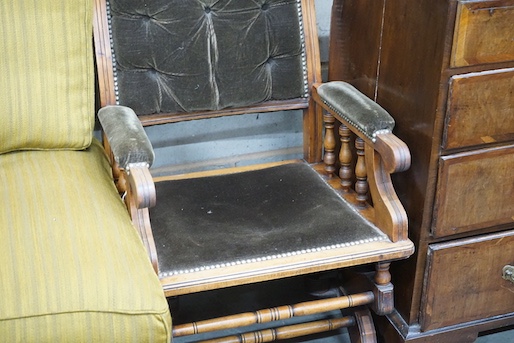 An early 20th century American upholstered mahogany rocking chair, width 58cm, depth 52cm, height 102cm